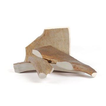 four jumbo moose paddles in a pile on a white background