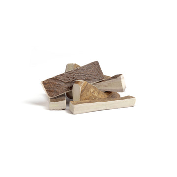 six small moose paddle antler chews in a pile on a white background